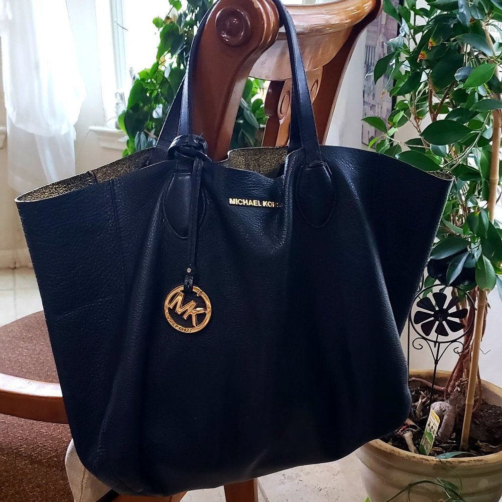 Michael Kors bag color black gold inside.
